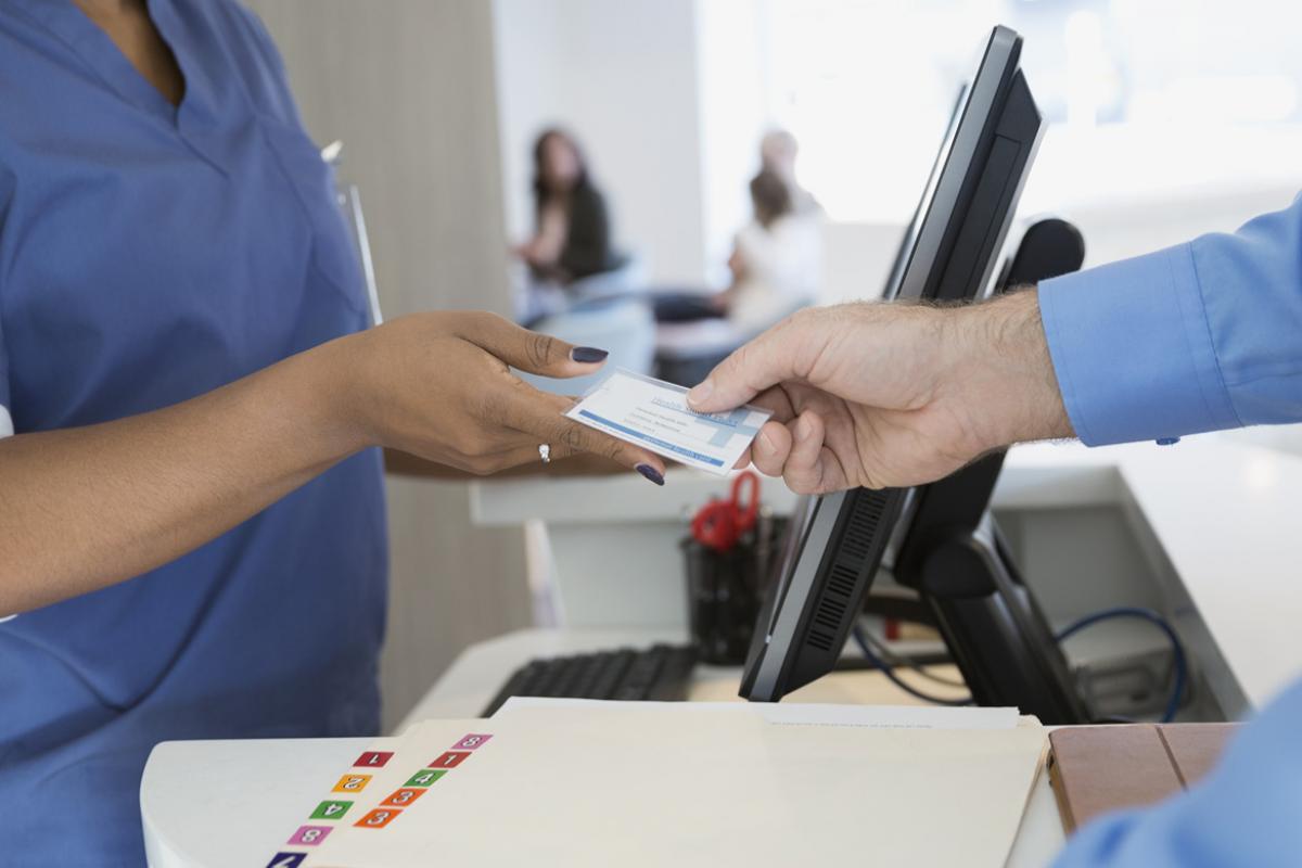 Patients handing over an insurance card