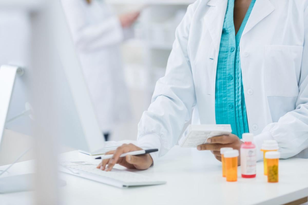 Physician working on an opioid prescription on the computer.