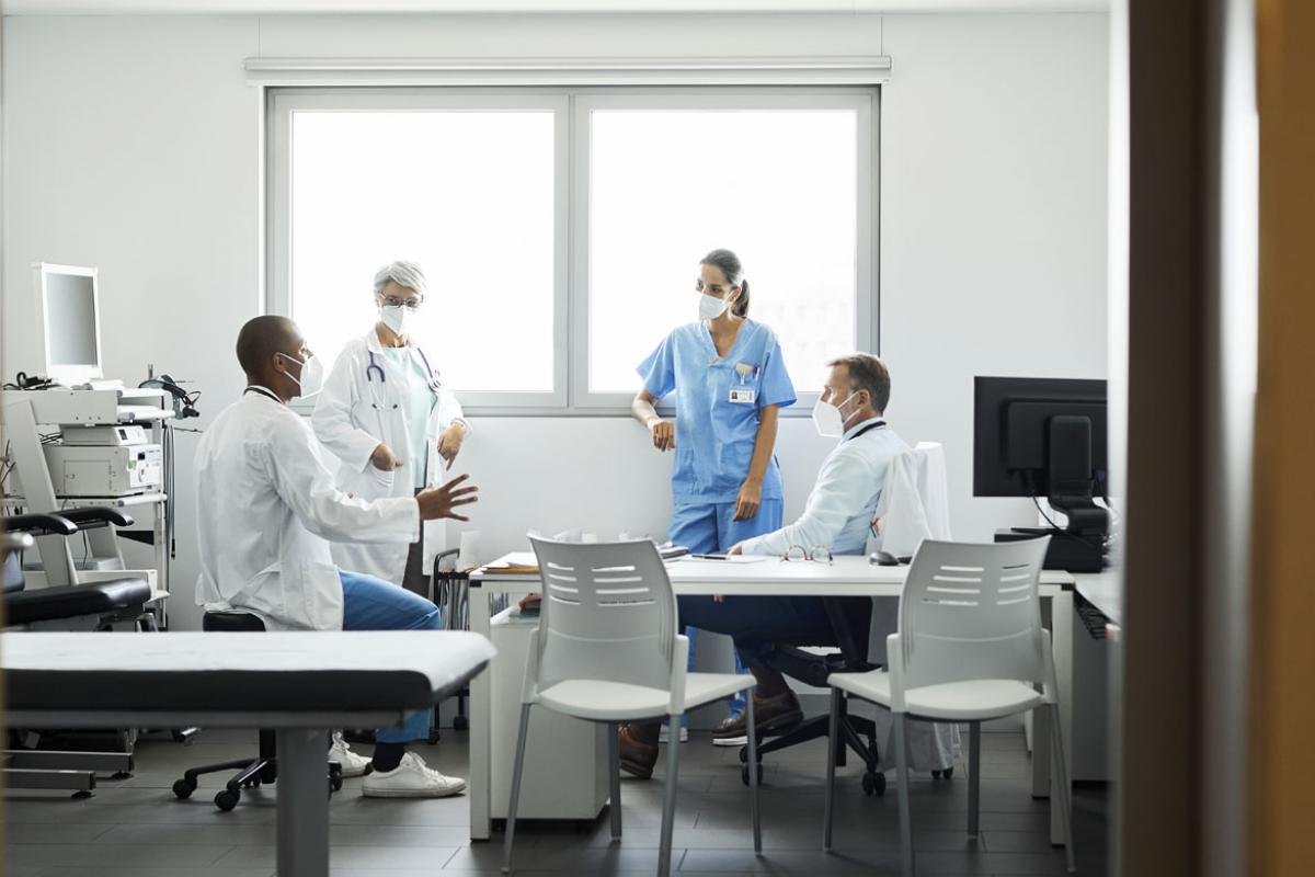 Physician care team discussing work