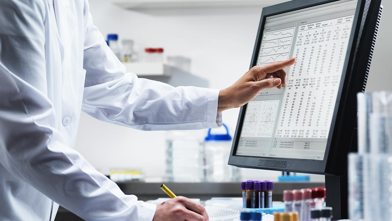 Physician or health care professional reviewing patient lab results on a computer desktop