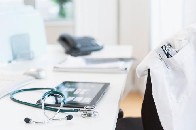 Tablet and stethoscope on desk