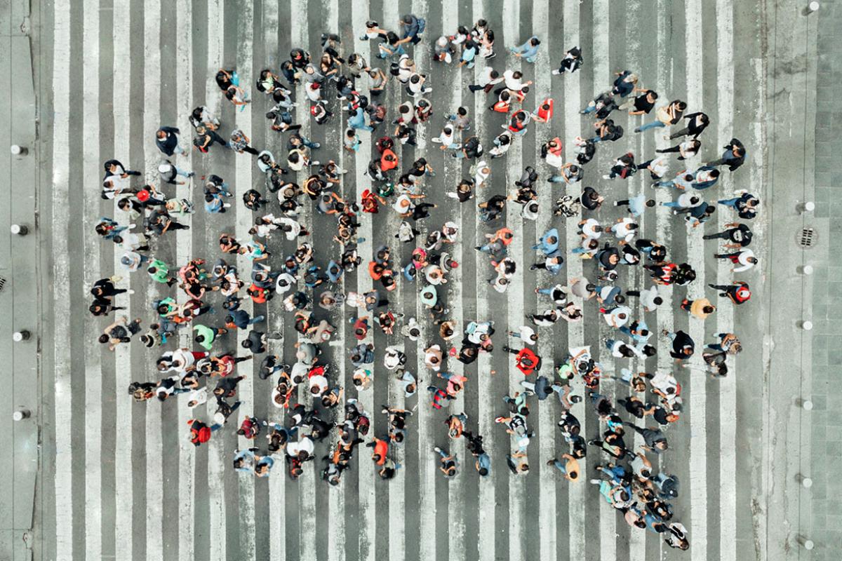 Overhead shot of a group of people shaped like a speech bubble