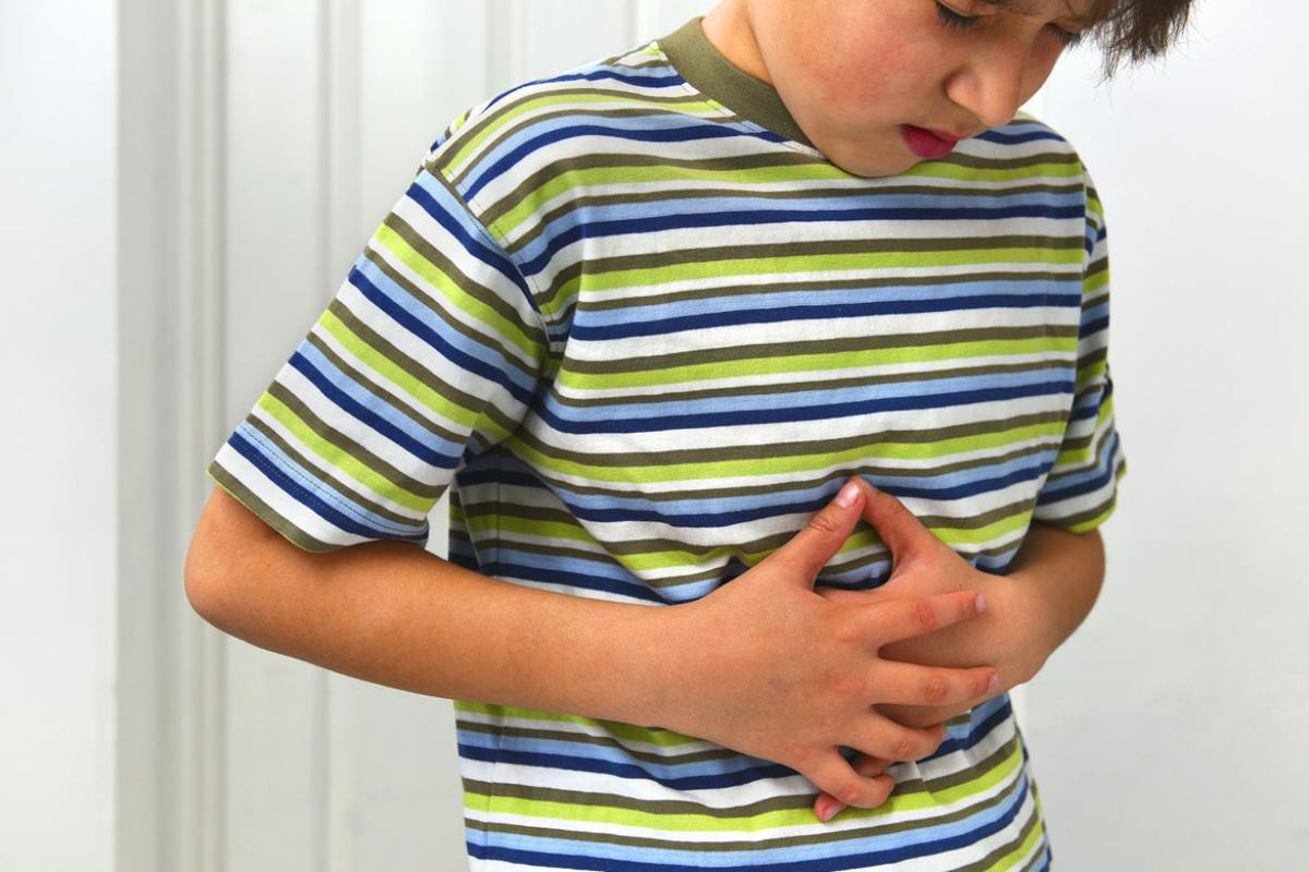 Child with hands on midsection