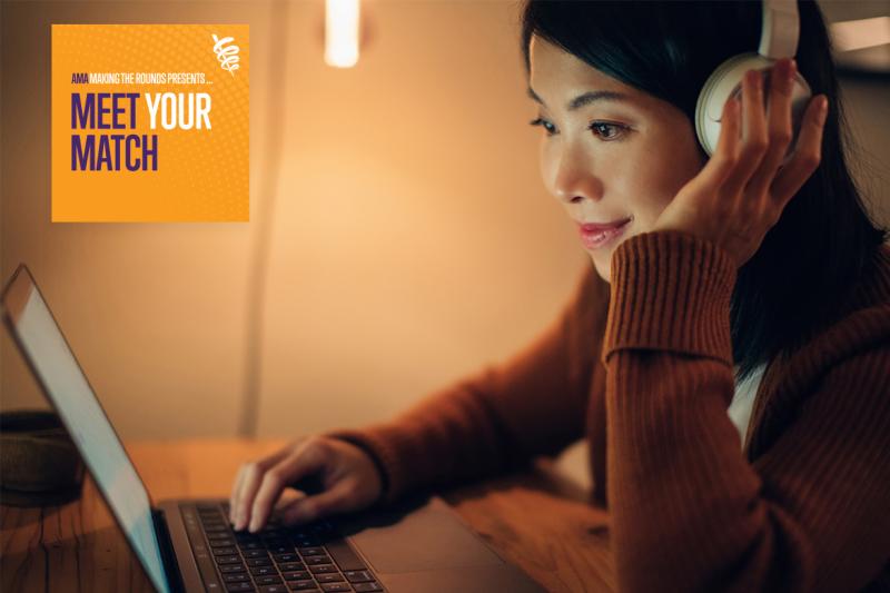 Young adult wearing headphones and working at a laptop