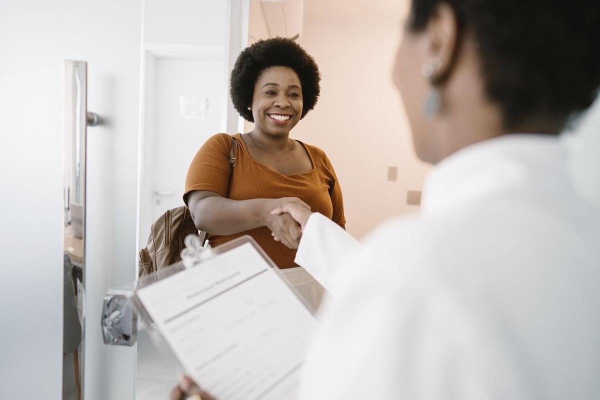 Smiling patient being greeted in a doctor's office