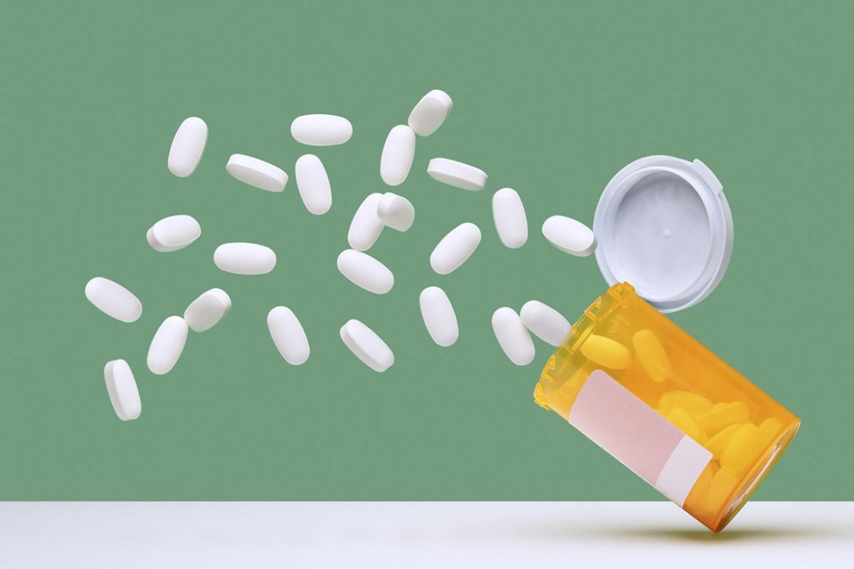 Pills tumbling out of a prescription bottle