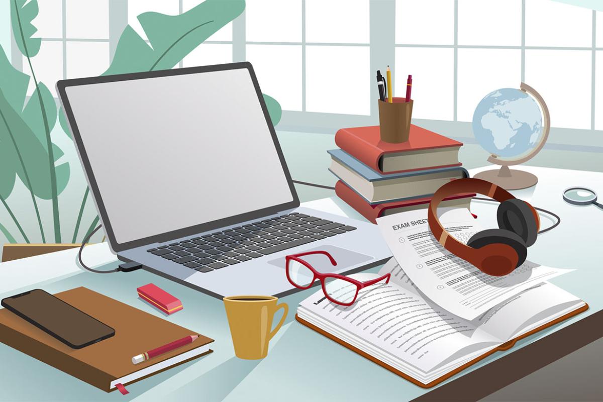 Laptop surrounded by various study materials