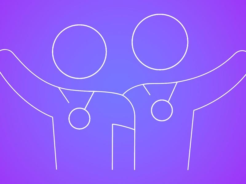 Two embracing figures wearing award medals