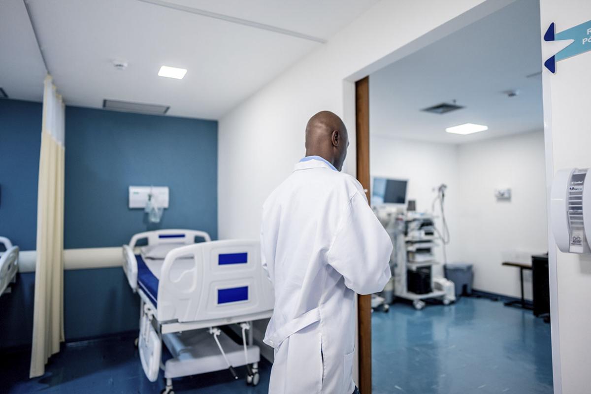 Doctor walking in hospital yard 