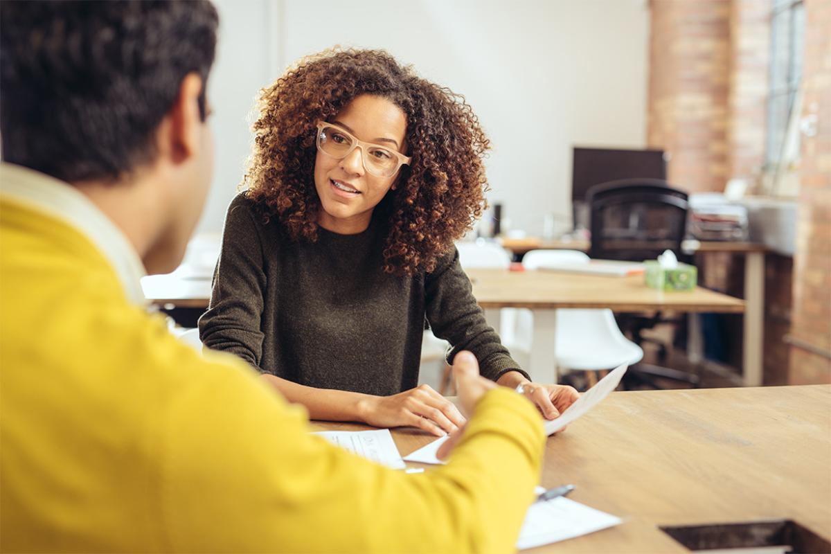 Two people in conversation in an office setting