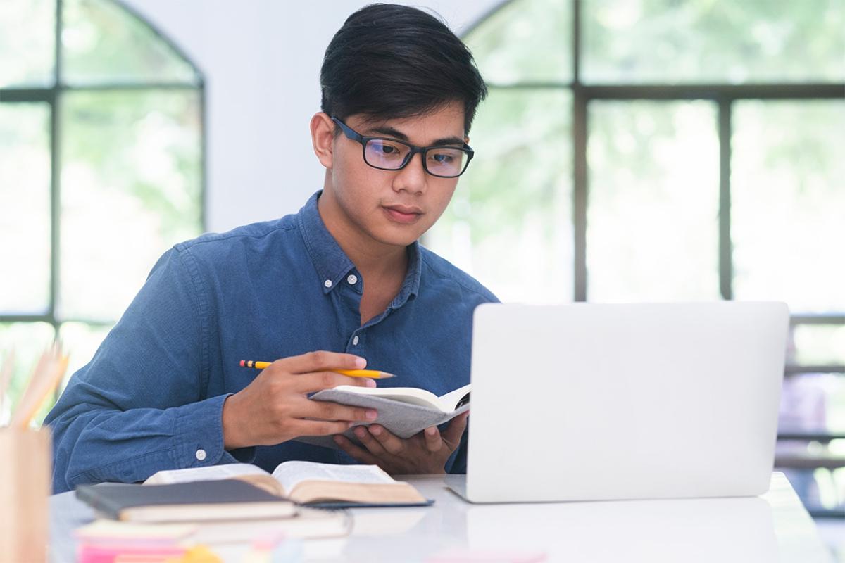 Person studying in front of a laptop