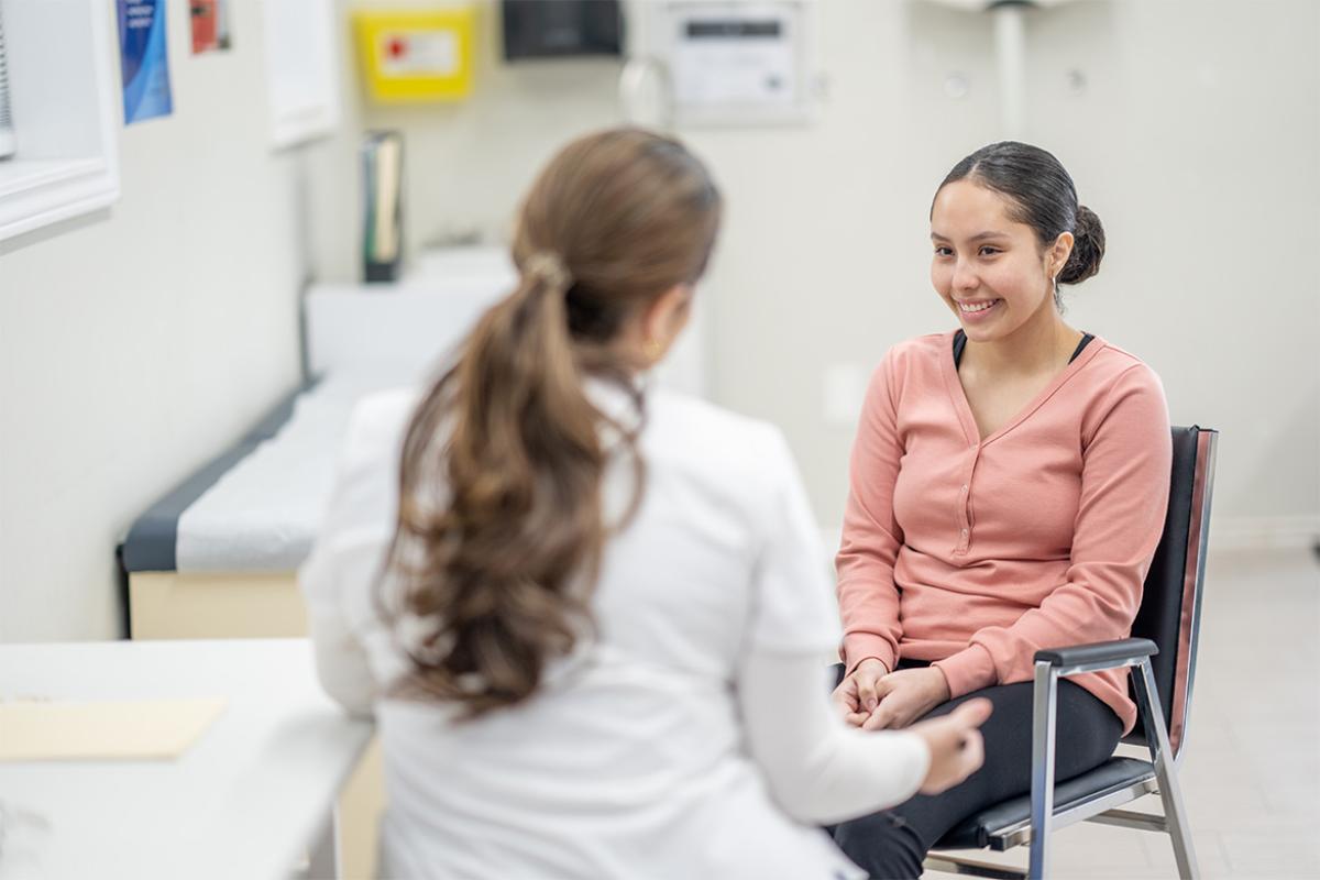 Medical student talking to smiling patient