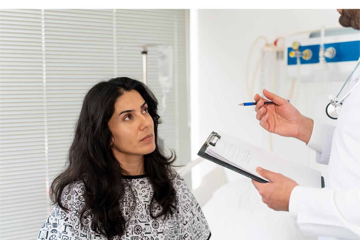 Patient sitting on examination table in doctor's office