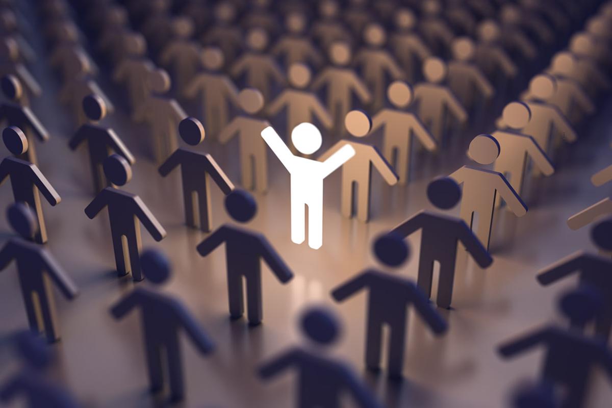 Crowd of figures with one illuminated in the center, arms upstretched