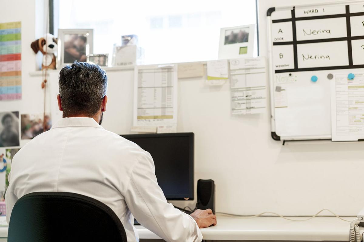 Physician working in front of computer