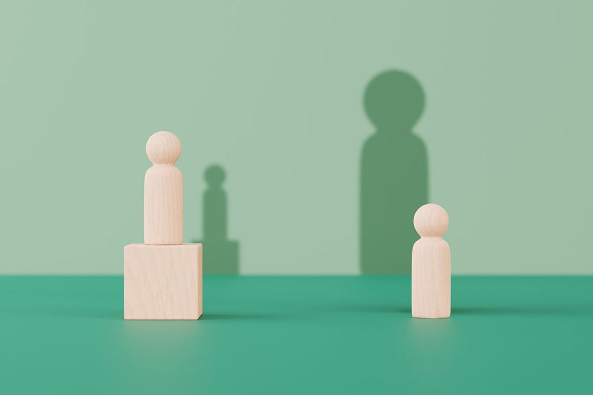 Two blocks shaped like figures, one taller than the other
