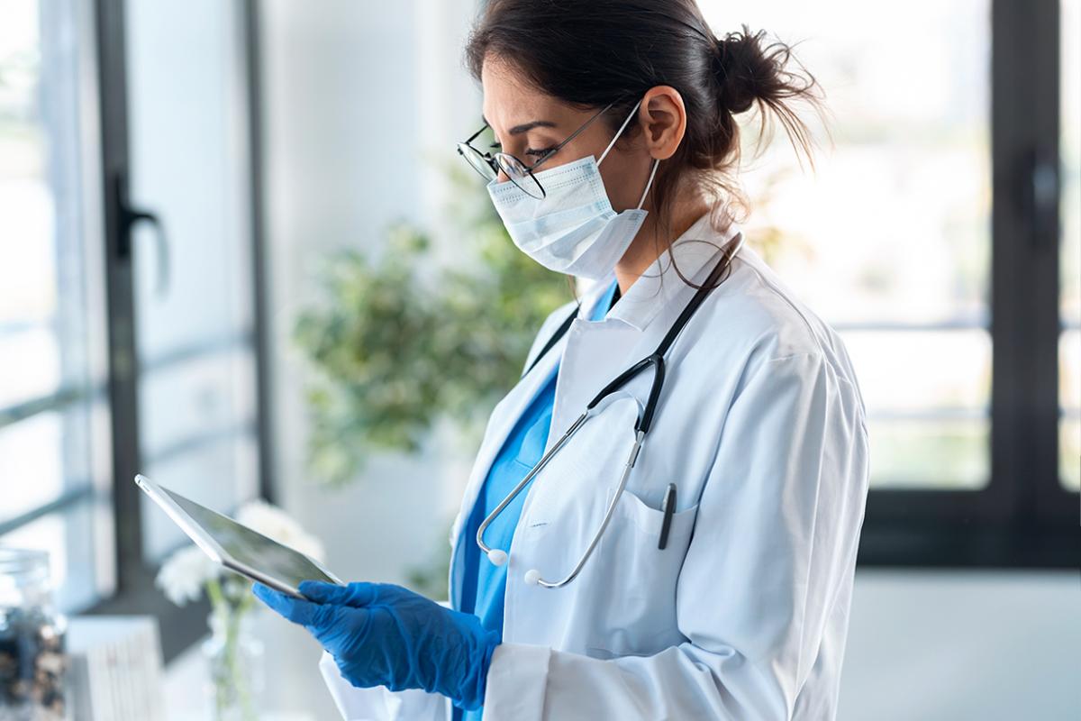 Physician looking down at tablet
