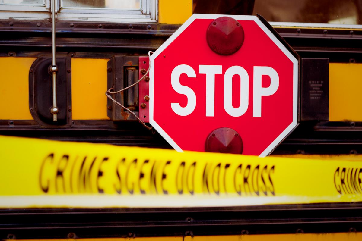 Stop sign and crime scene tape saying 'Do Not Cross'
